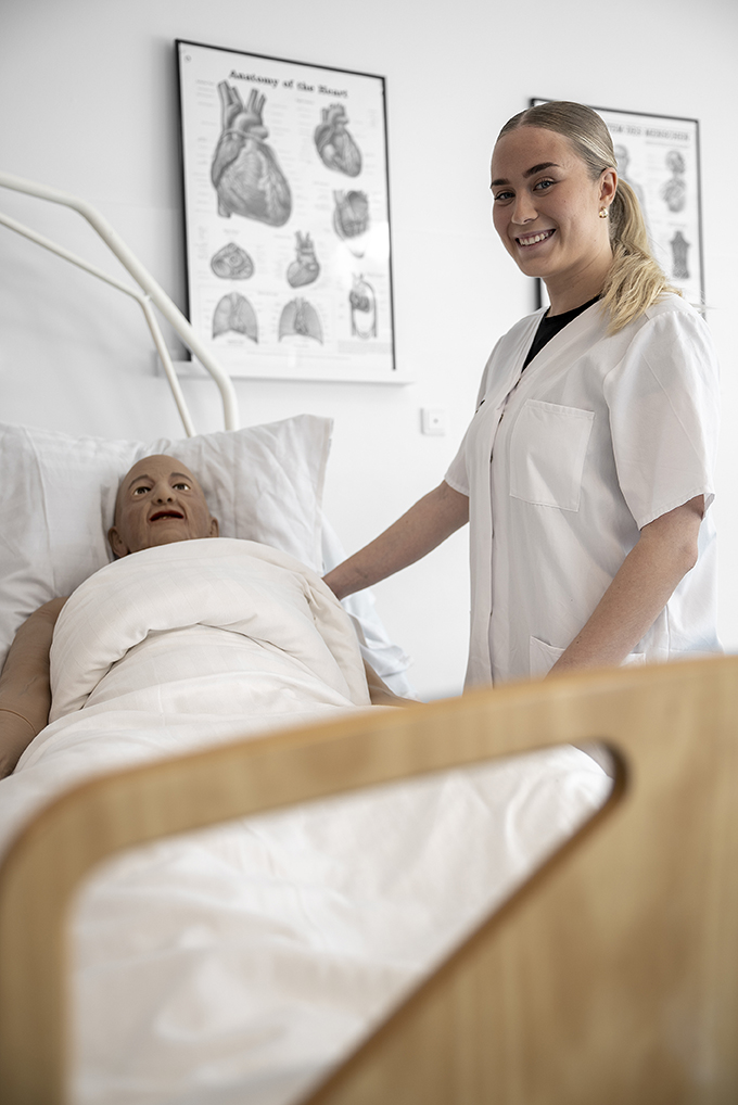 Elev fra Uddannelsen Til Social Og Sundhedsassistent arbejder med patienter i demostuen
