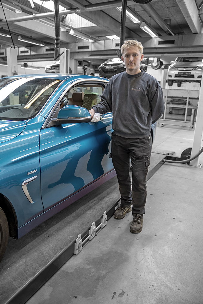 Elev fra uddannelsen til perosnvognstekniker arbejder på biler
