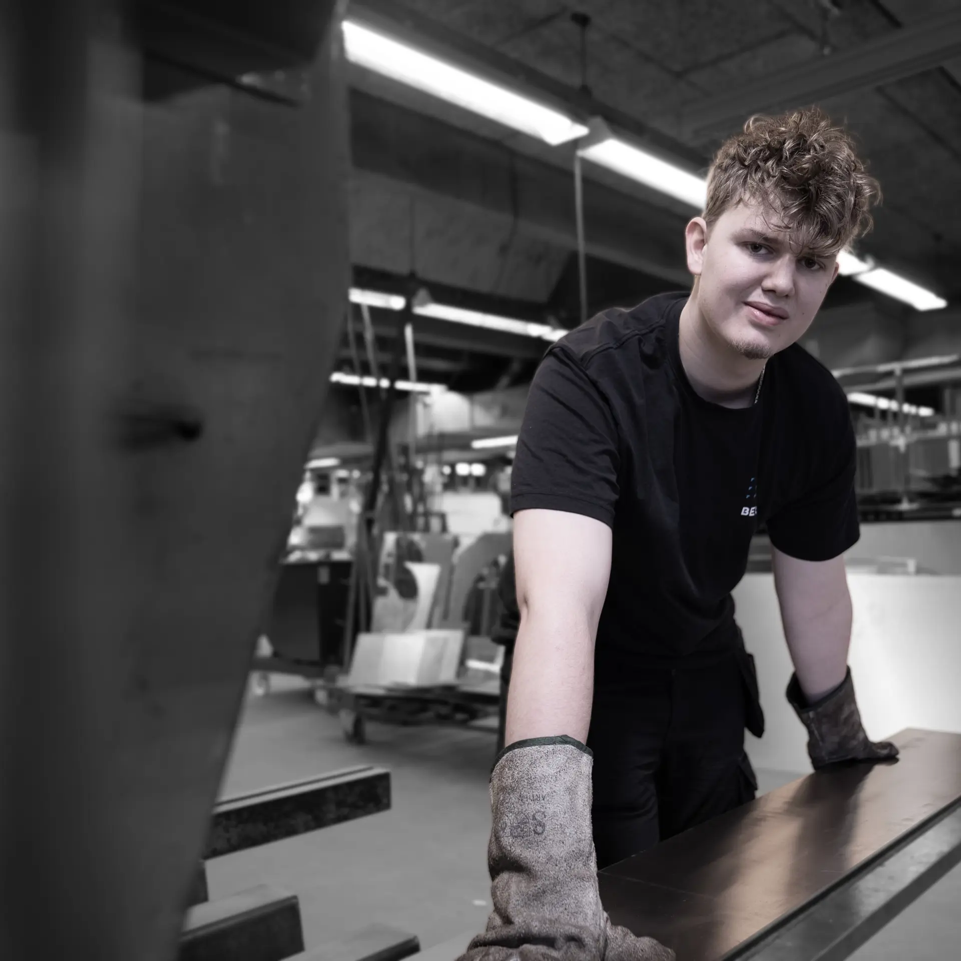 Elev på smedeuddannelsen med metal på værksted